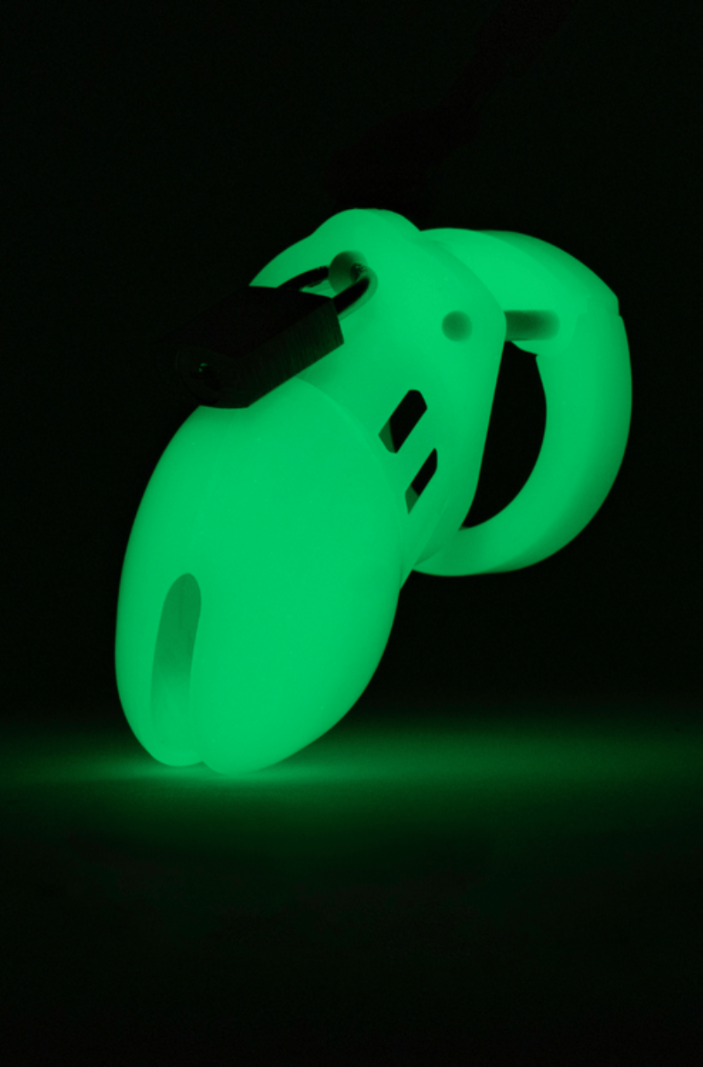 CB-6000S chastity cage glowing green in the dark with a numbered black plastic lock attached.
