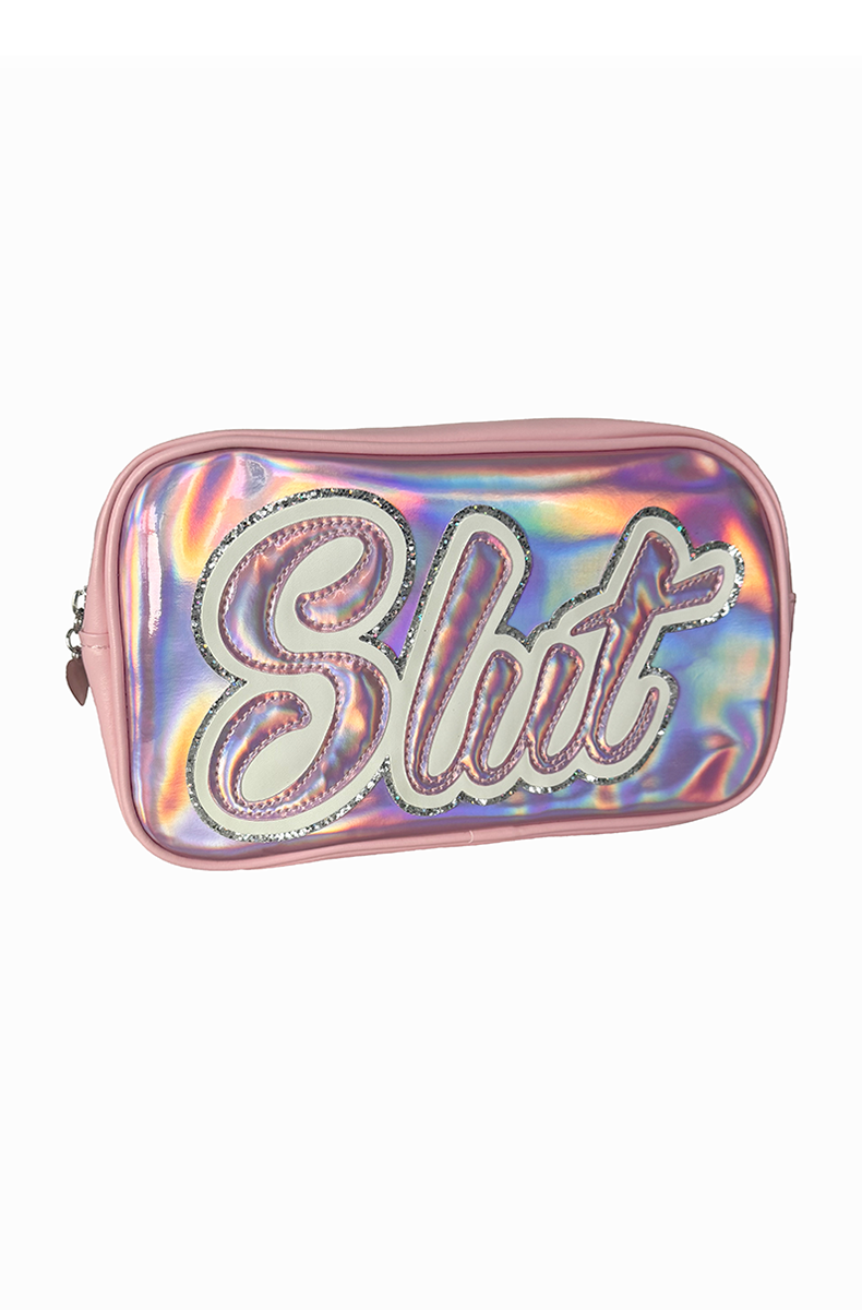 Pink and iridescent silver-pink holographic travel bag with bold "Slut" lettering in script, outlined and trimmed in clear glitter, with a top metal zipper.