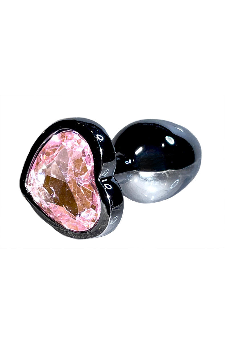 Close-up of rose-gold metal anal plug topped with a pink heart-shaped jewel base.