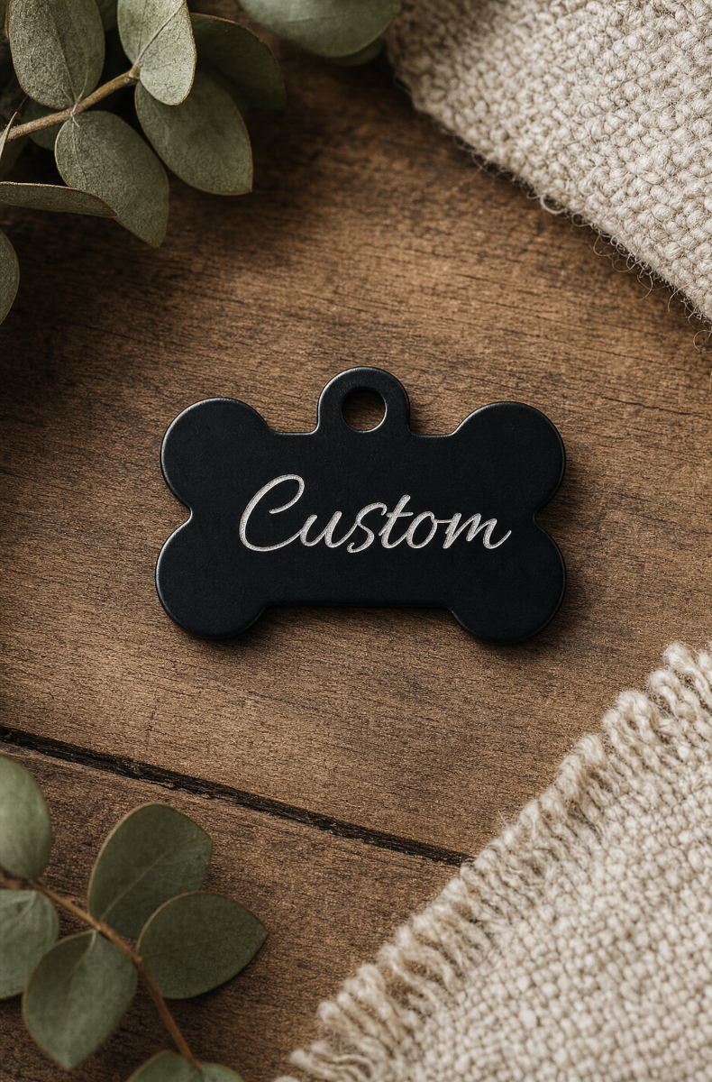 Custom engraved bone pet play collar tag shown in an anodized color finish