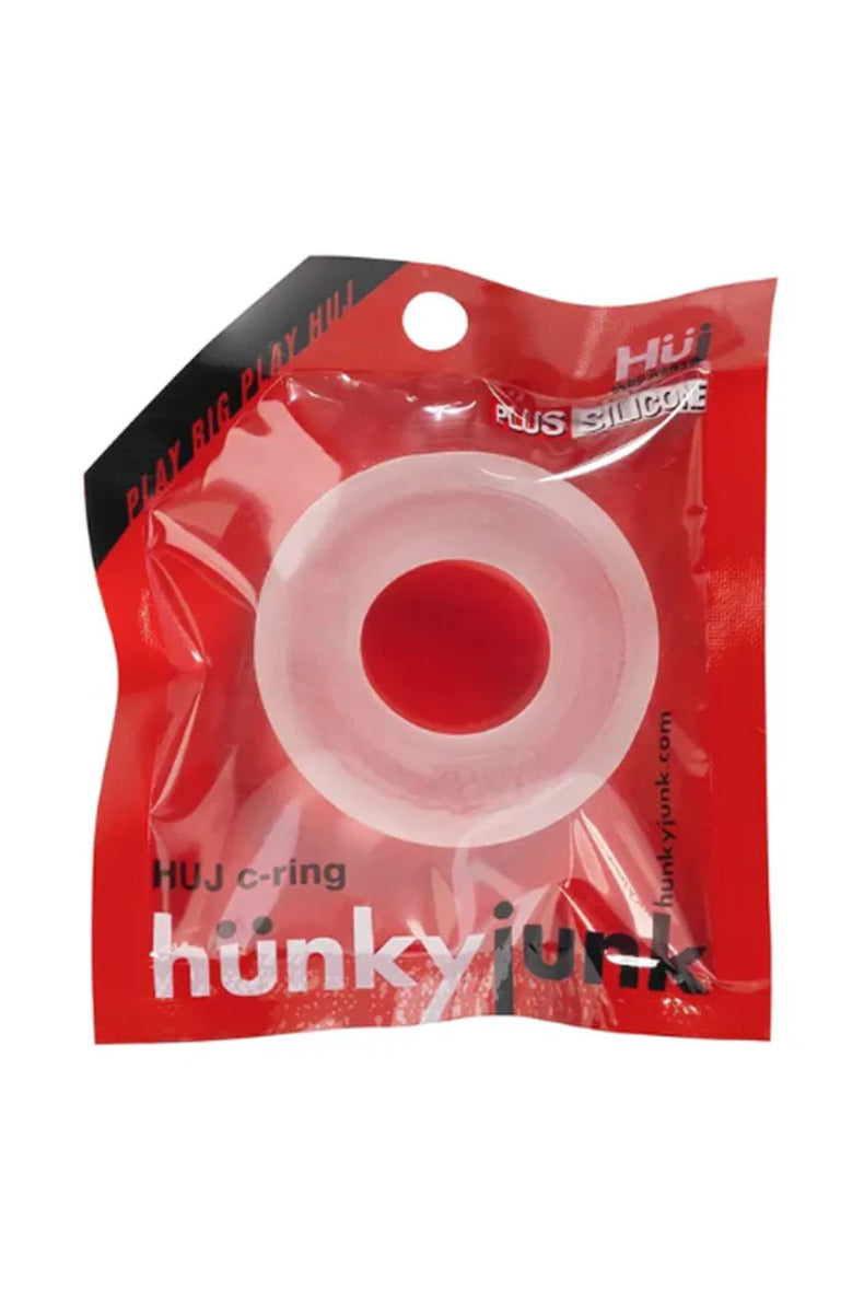 Ice clear Hünkyjunk HUJ thick silicone cock ring in its red Hünkyjunk package, on a white background.