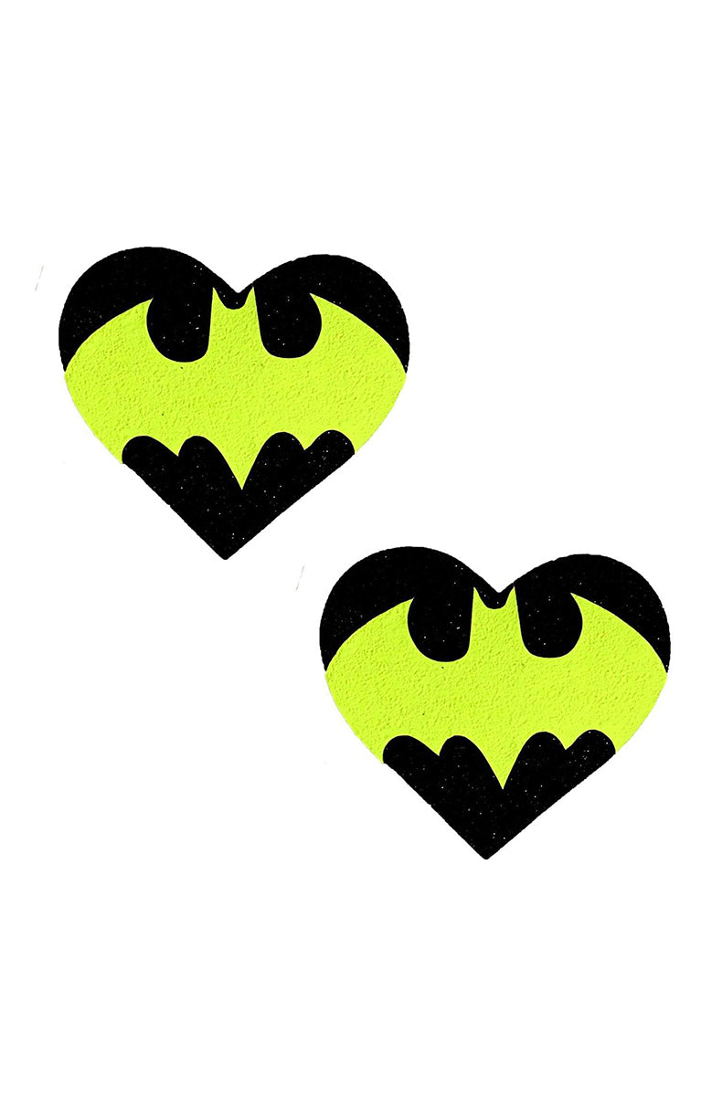 Two heart-shaped pasties with a black glitter bat silhouette printed over a neon yellow background.