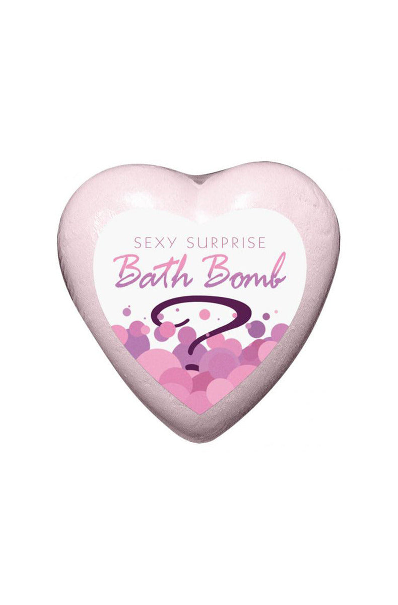 Pink heart-shaped Sexy Surprise bath bomb with a white heart label reading Bath Bomb and a purple question mark.