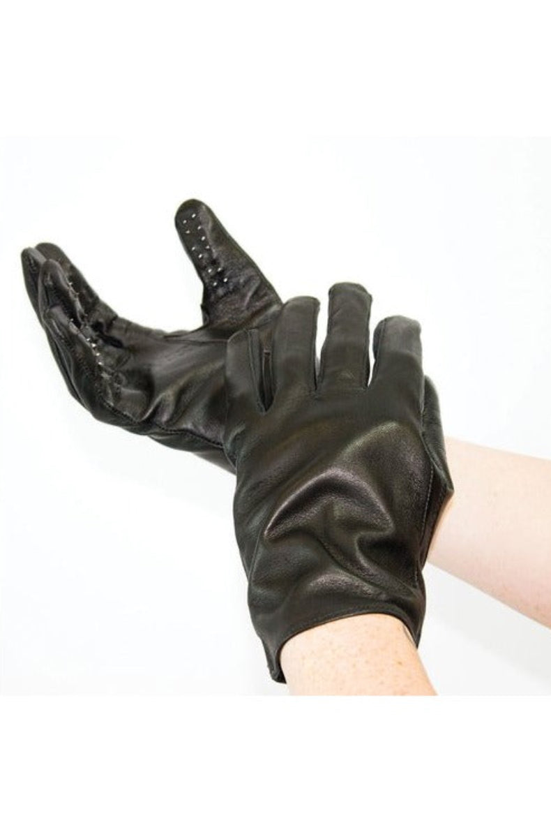 Black leather vampire glove worn on a hand, showing small metal points across the fingers and palm.