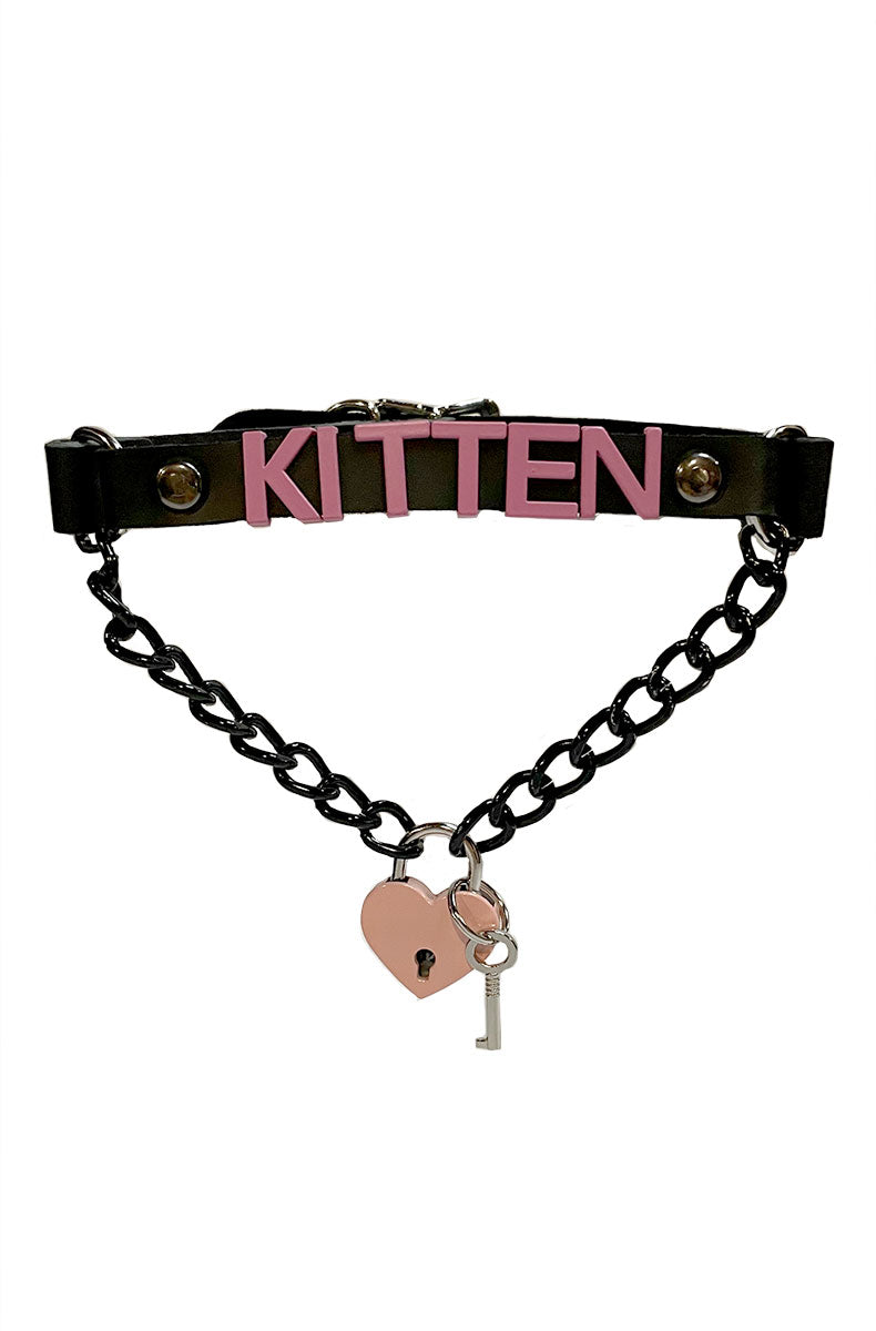 Black vegan-leather collar with "KITTEN" in pink lettering, a black chain swag below, and a pink heart-shaped padlock with a silver key.