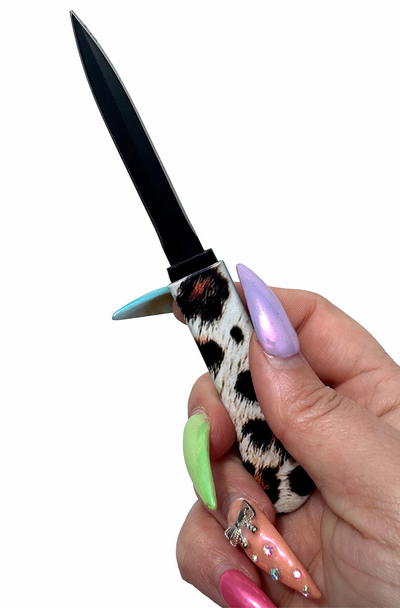 Woman using leopard print concealed blade comb for everyday lifestyle protection