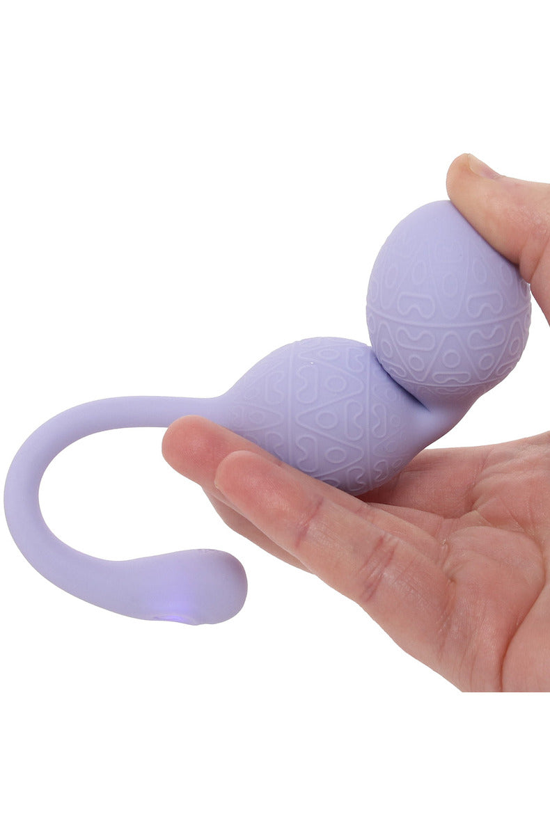 Close-up of the lavender textured silicone beads of the kegel vibrator held in a hand.