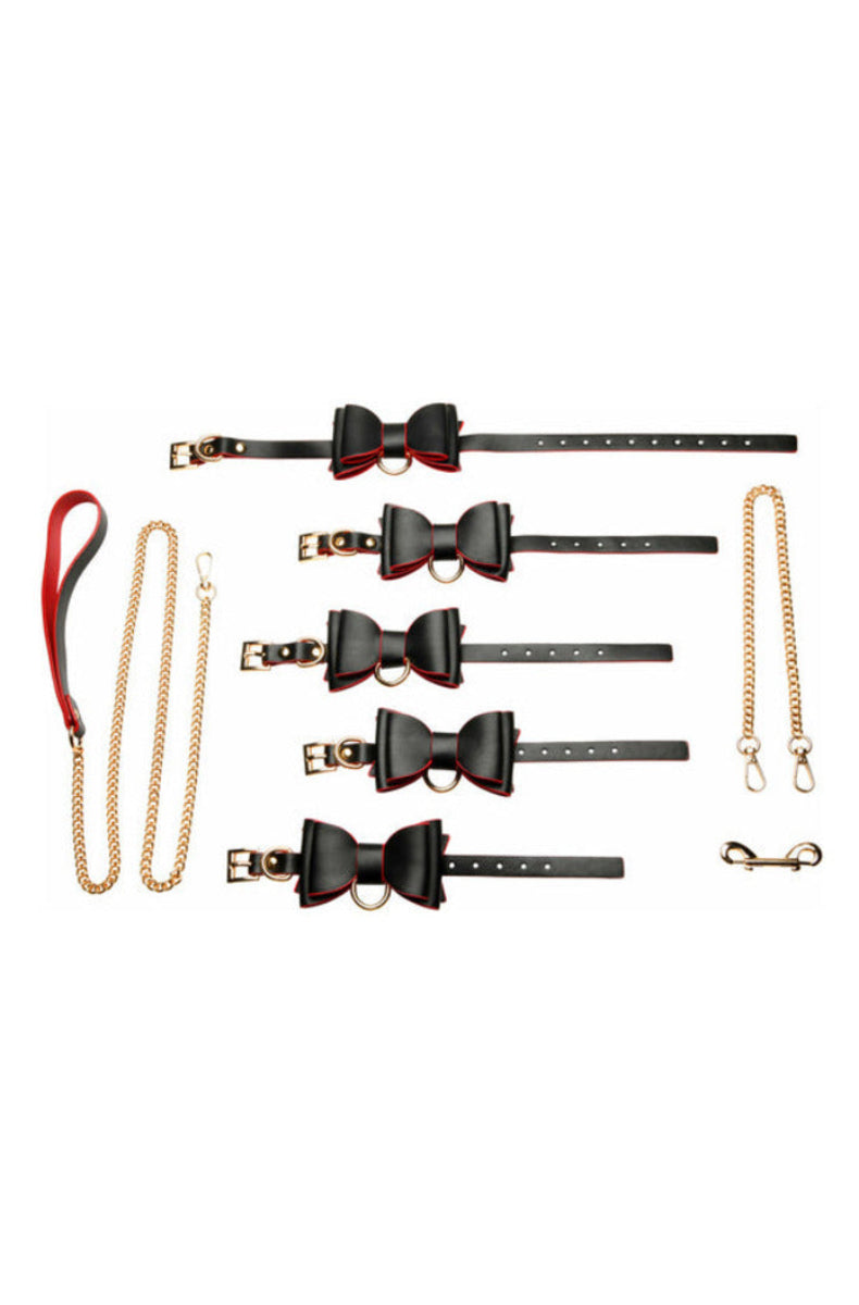 Flat lay of the goth bondage set: bow collar, four bow cuffs, gold chain leash, chain connector, and snap hook, on white.