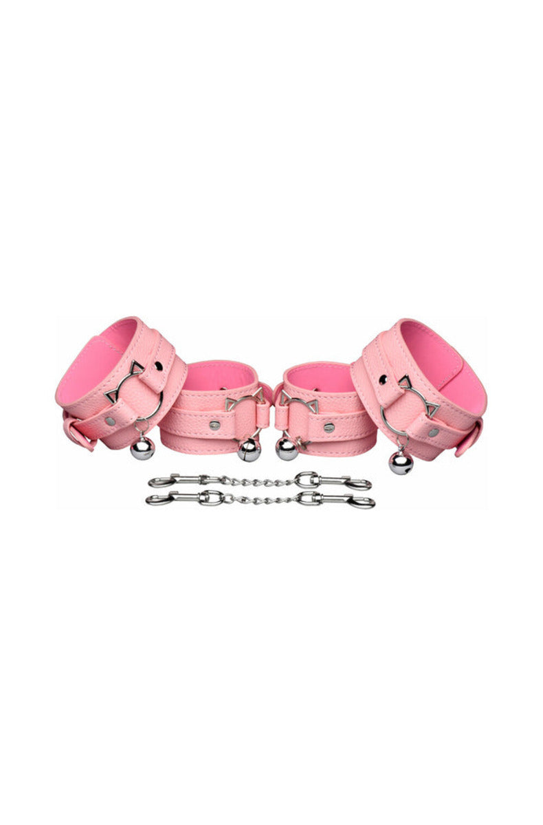 Pink kitty cuffs with bells and two silver chain cuff connectors with clips, on a white background.
