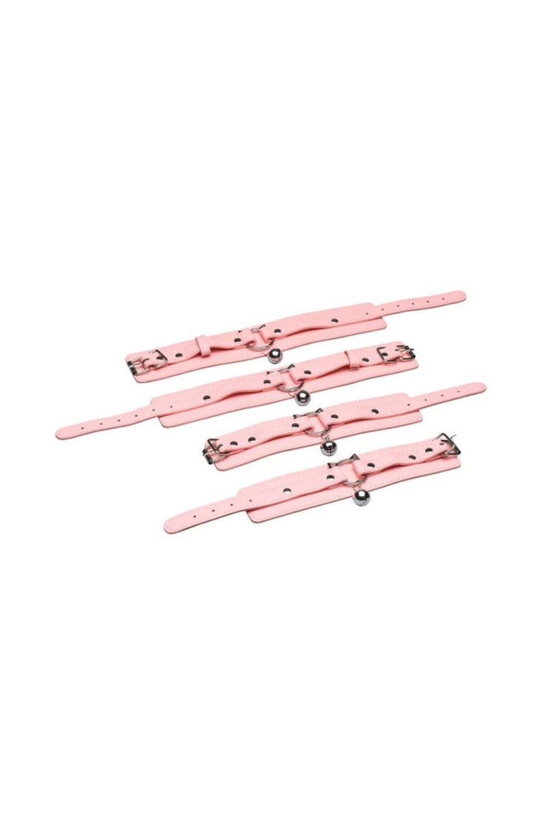 Four soft pink cuffs with kitty-head O-rings and small silver bells, on a white background.