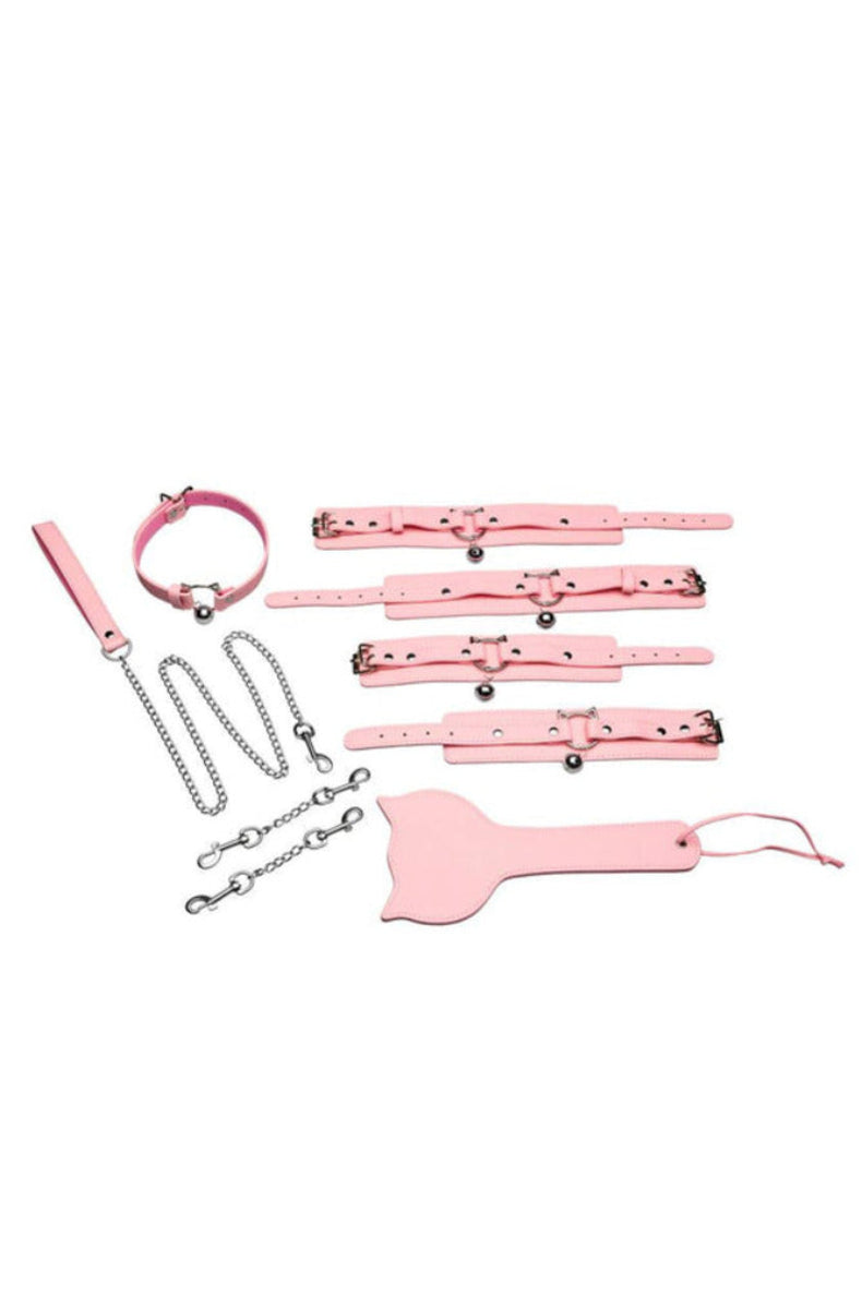 Pink kitty bondage set laid out with collar, leash, four belled cuffs, chain connectors, and a kitty-head paddle.
