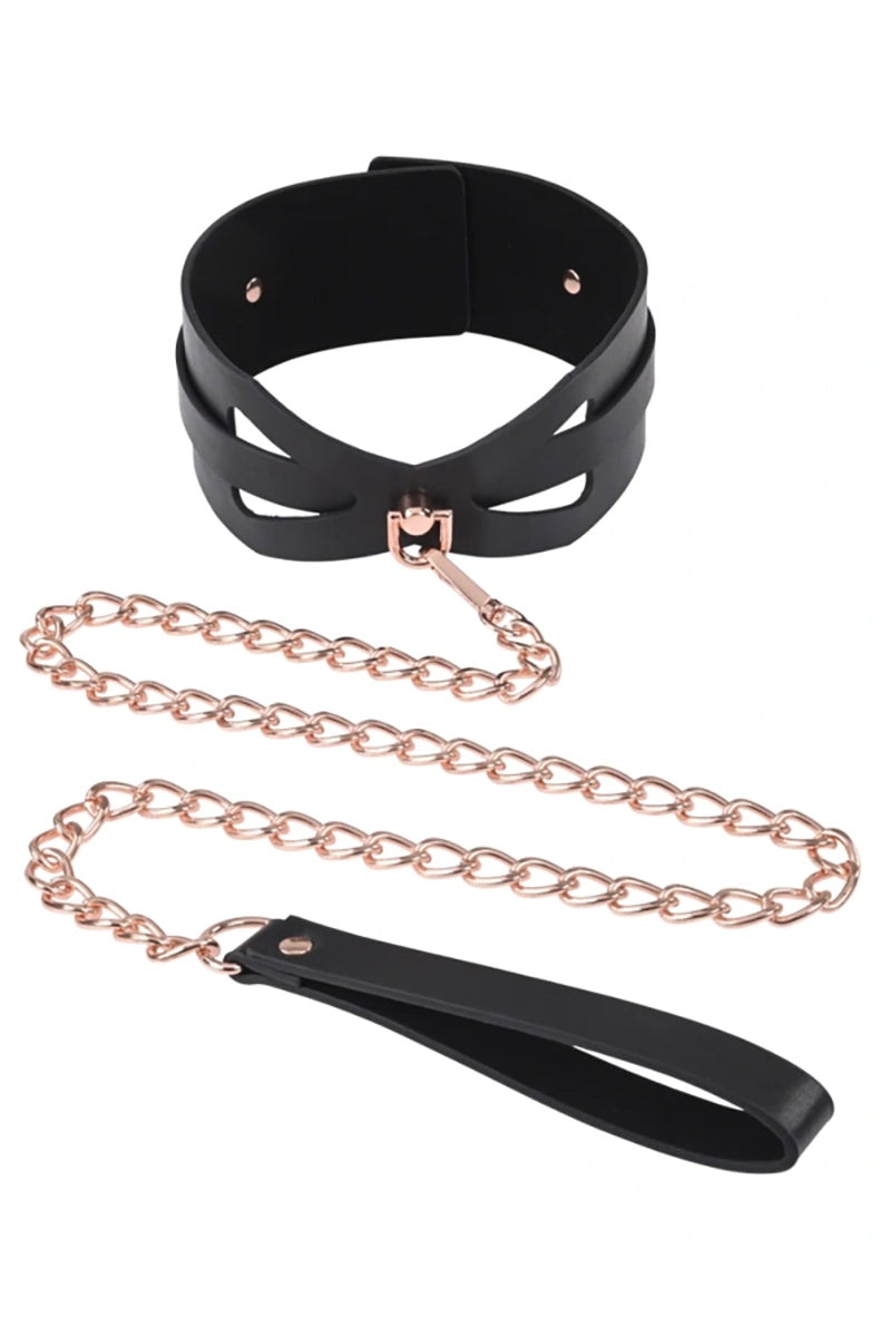 Wide black PU faux leather collar with corset cutouts and rose-gold D-ring, with a rose-gold chain leash on a PU loop.