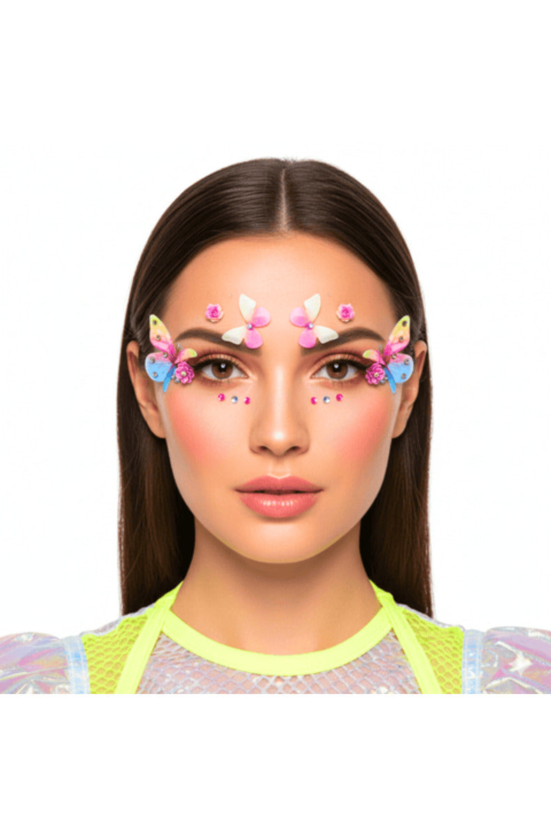 Model wearing the pastel butterfly face jewels with butterflies, pink roses, and gems around the eyes and brows.