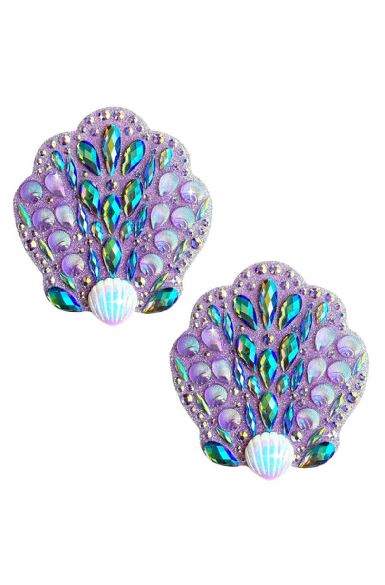 Pair of seashell nipple pasties covered in iridescent teal and clear jewels on a lavender glitter base, pearl center.