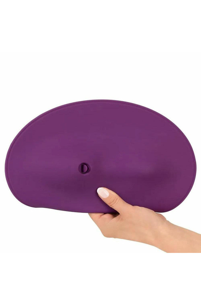 Purple Orion VibePad 2 grinding pad held in hand for scale