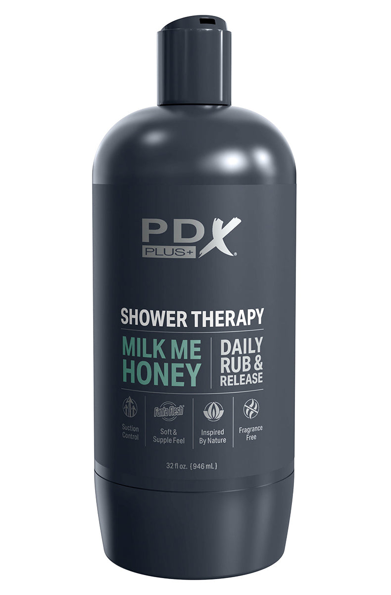 PDX Plus Shower Therapy Milk Me Honey stroker bottle next to its suction cup base in soap suds.