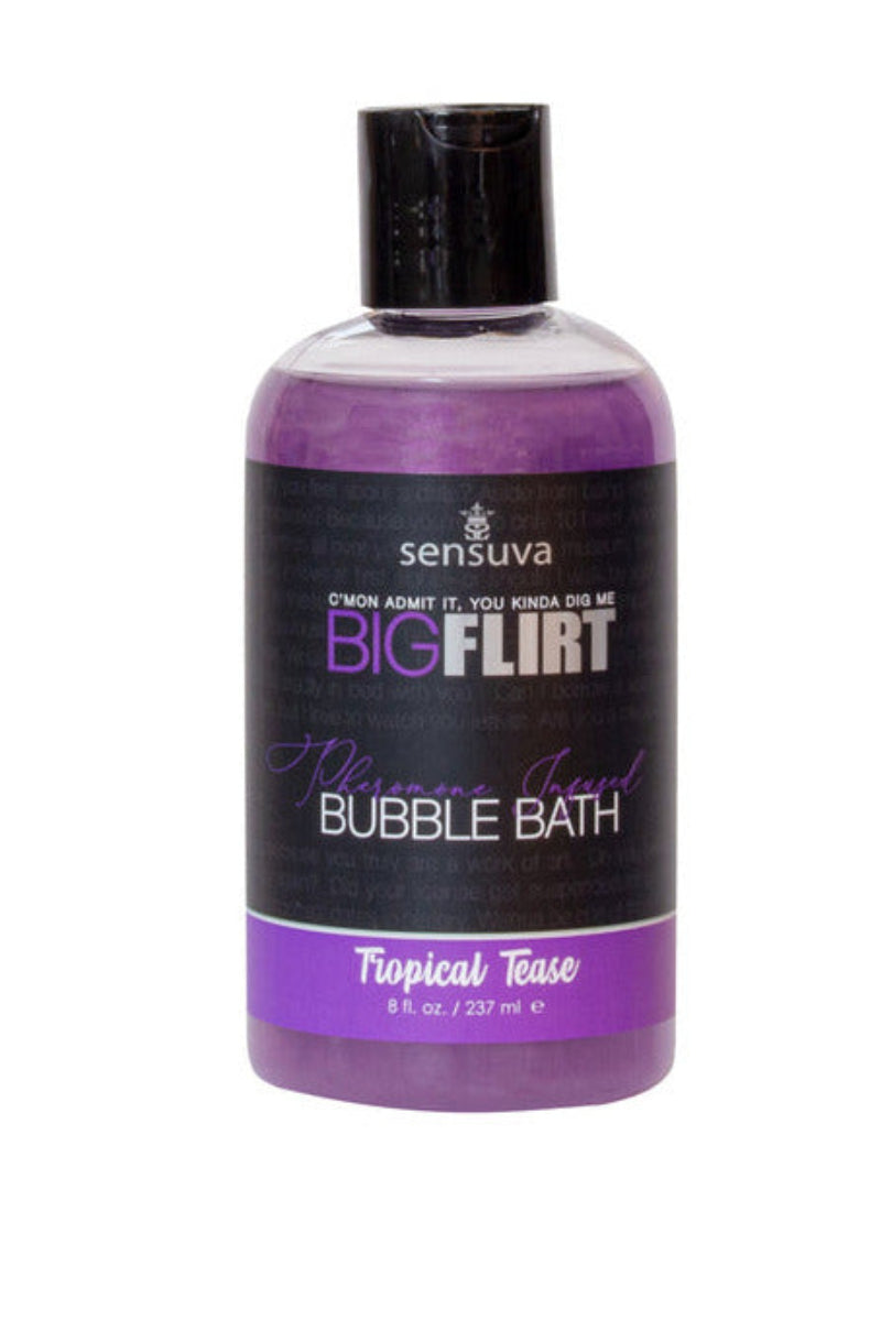 Sensuva Big Flirt pheromone bubble bath in Tropical Tease, purple liquid in a clear 8 oz bottle with a pickup-line label.