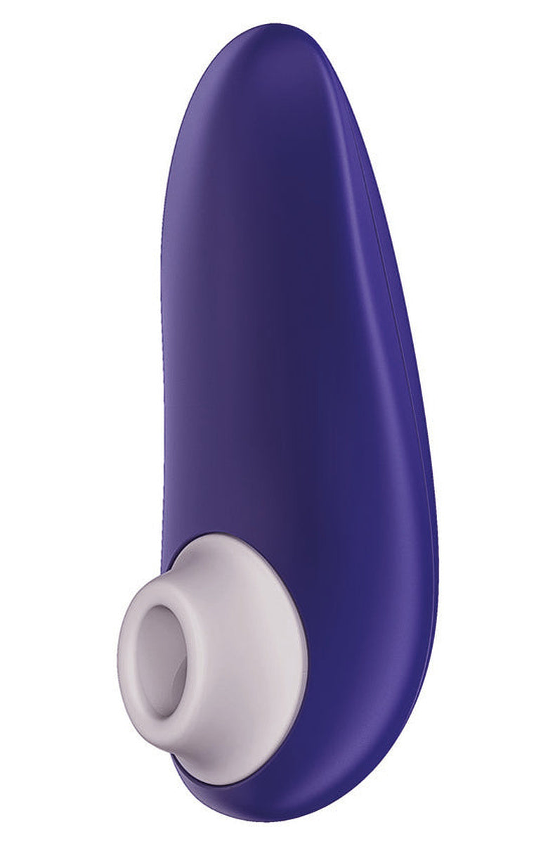 Indigo Womanizer Starlet 3 with its white silicone head, angled to show the curved compact body.