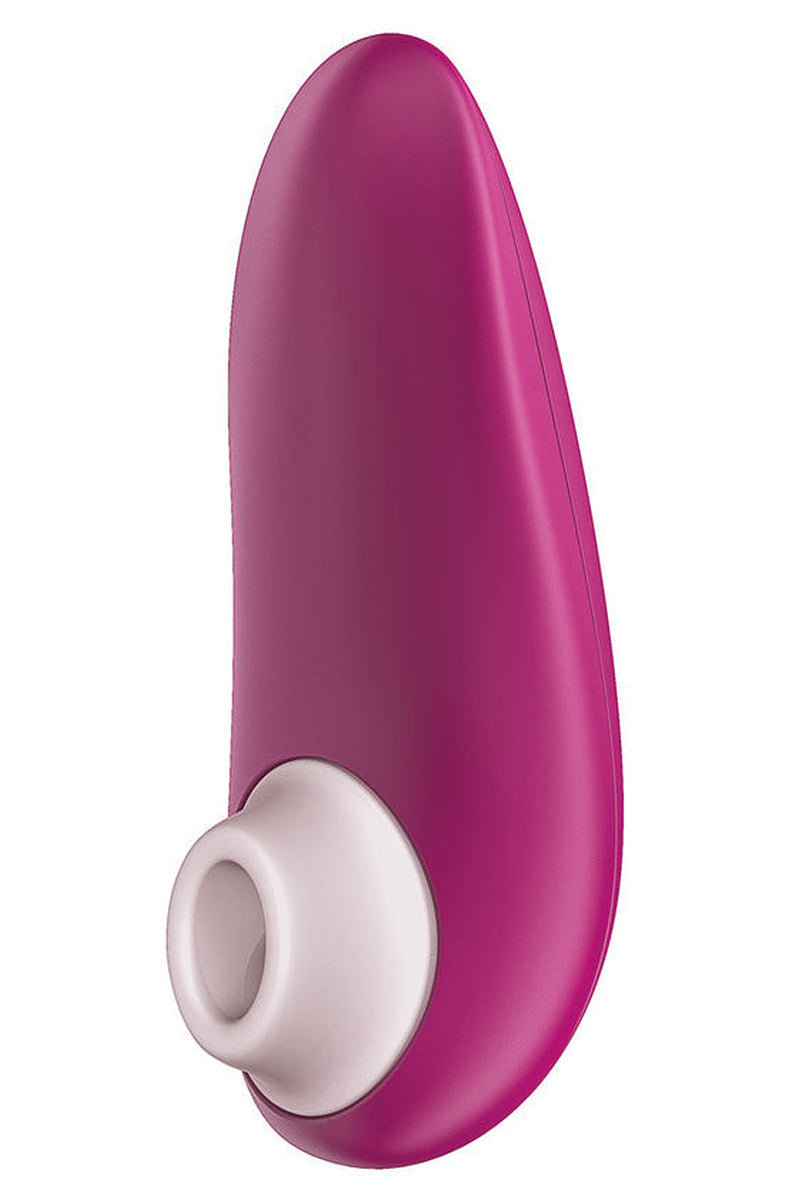 Pink Womanizer Starlet 3 with its white silicone head, angled to show the curved compact body.