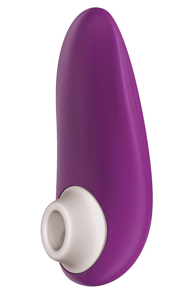 Violet Womanizer Starlet 3 with its white silicone head, angled to show the curved compact body.
