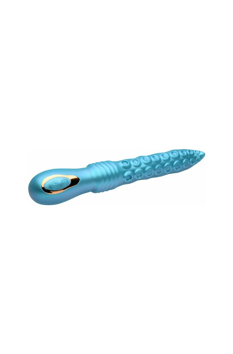 Side view of the vibrator laid flat, showing the curve of the shaft and the tentacle texture