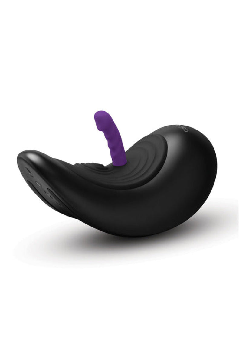 The Cowgirl Saddle ride-on sex machine with a purple attachment docked in place