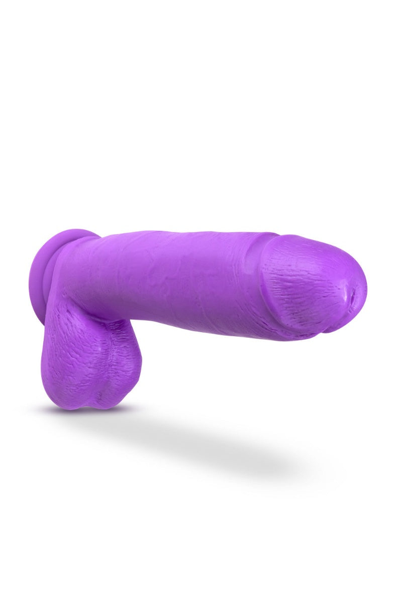 Horizontal view of purple dildo showing curved shaft profile and suction cup base