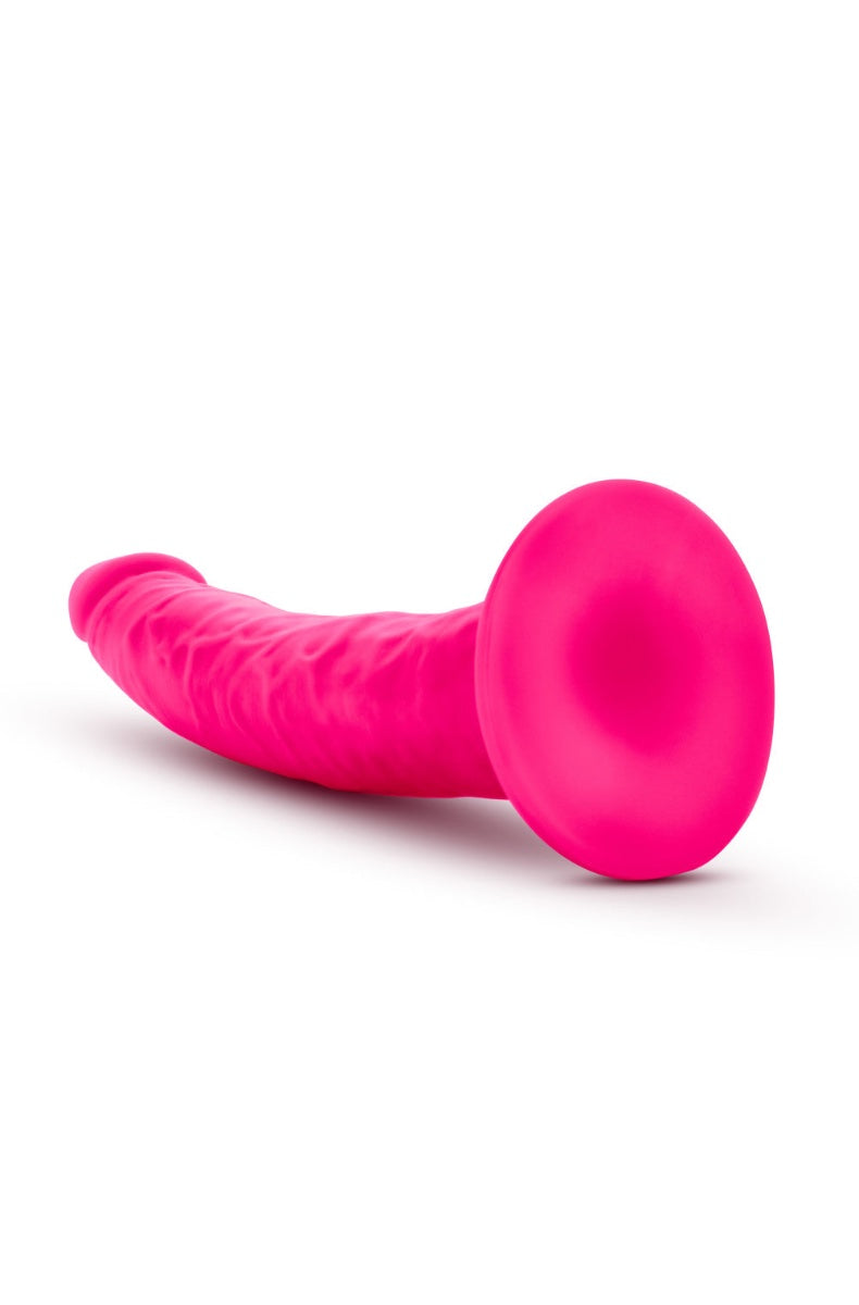 Cross-section view of pink dildo showing soft outer layer and firm inner core construction