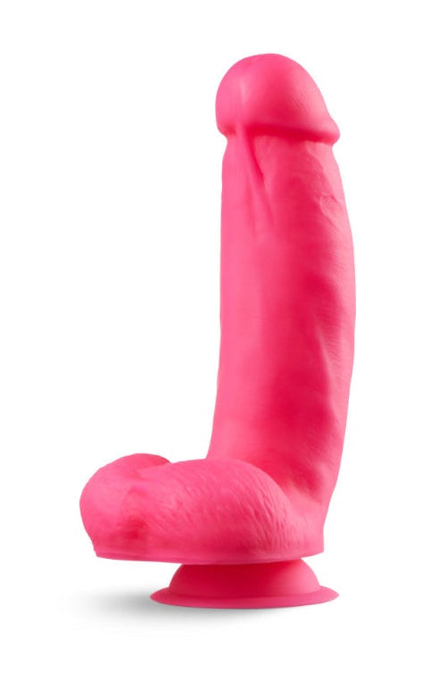 Side view of pink silicone dildo with realistic head, textured shaft, and suction cup base