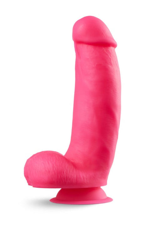 Side profile view of pink silicone dildo against white background showing realistic curves and suction cup base