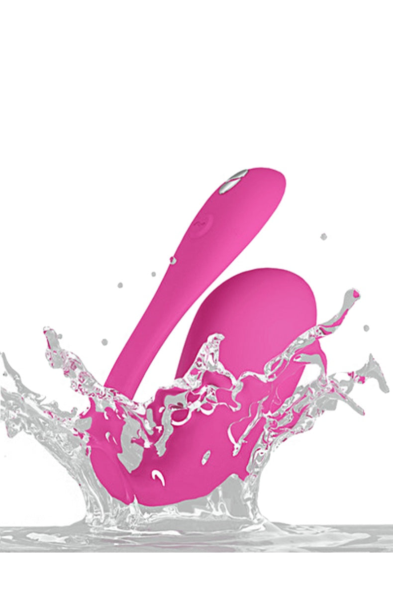 Pink dual-motor wearable vibrator with curved insertable end and external arm in water splash