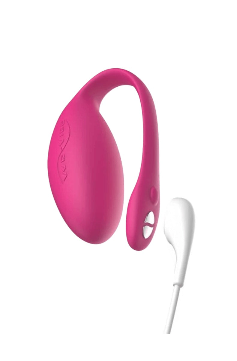 Pink wearable vibrator with white USB charging cable attached