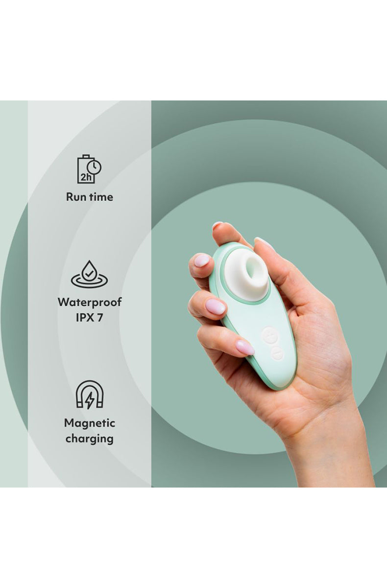 Sage Womanizer Liberty 2 with USB magnetic charging cable attached to the base.
