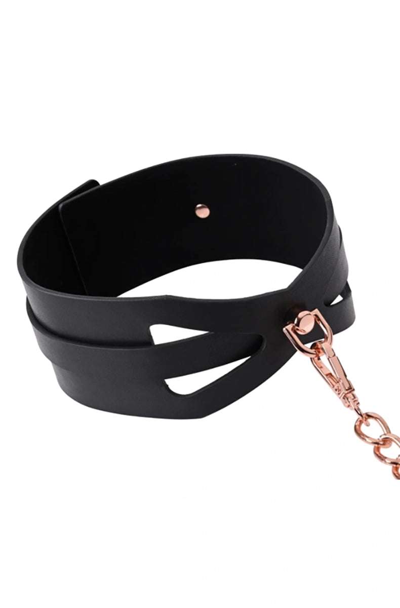 Detail view of the wide black PU collar showing the corset cutouts, rose-gold rivet, and rose-gold leash clip at the front.