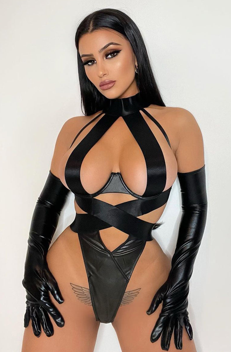 Black vegan leather and wide satin elastic strappy open-cup teddy with a high mock-collar halter neck, crisscross satin straps wrapping the body, and a vegan leather thong panel at the front of the bottom.