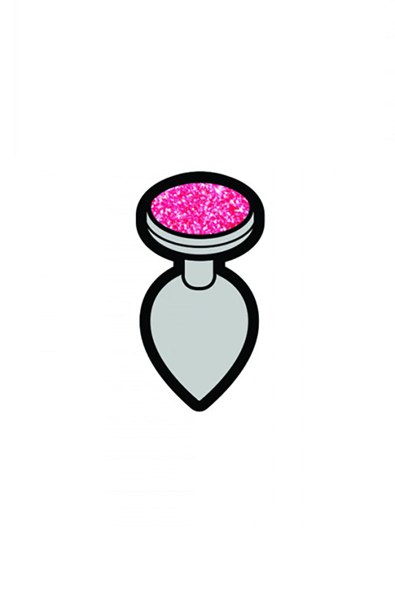 Miniature enamel pin shaped like a butt plug, white body with sparkly pink jeweled base, attached to a denim jacket pocket.
