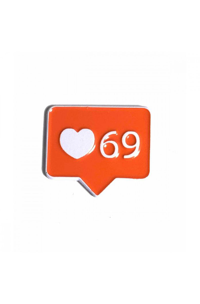 Red speech-bubble enamel pin shaped like a notification badge, holding a white heart icon and the number 69.
