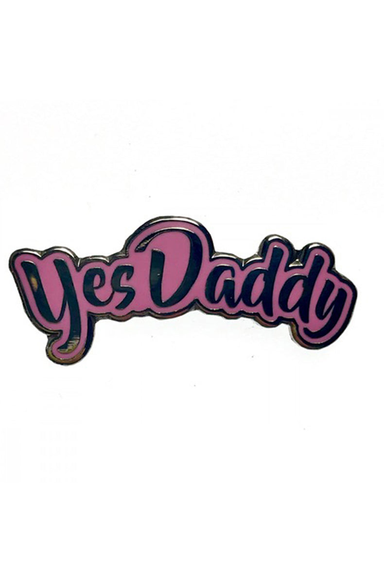 Pastel-pink enamel pin shaped to follow the cursive words "Yes Daddy" with a polished silver outline.