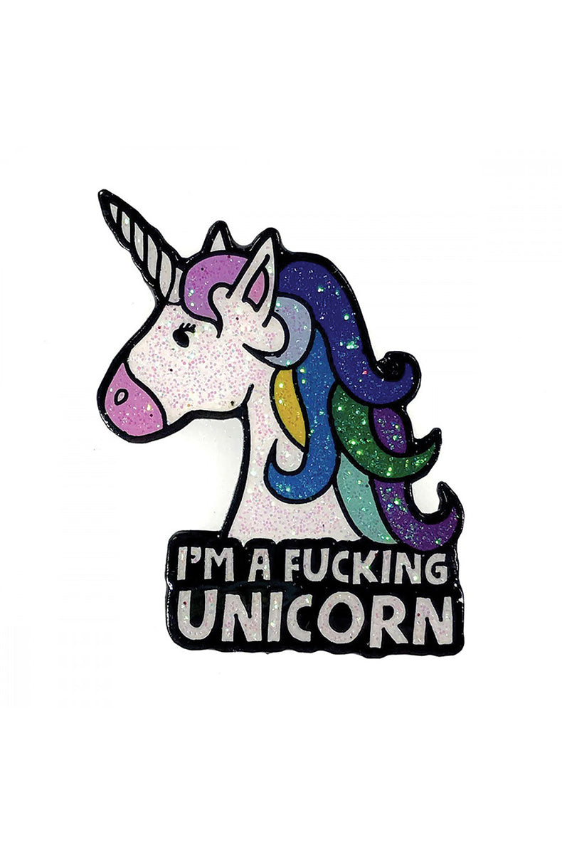 Glittery rainbow unicorn-head enamel pin paired with a black banner reading I'M A FUCKING UNICORN, attached to a denim jacket pocket.