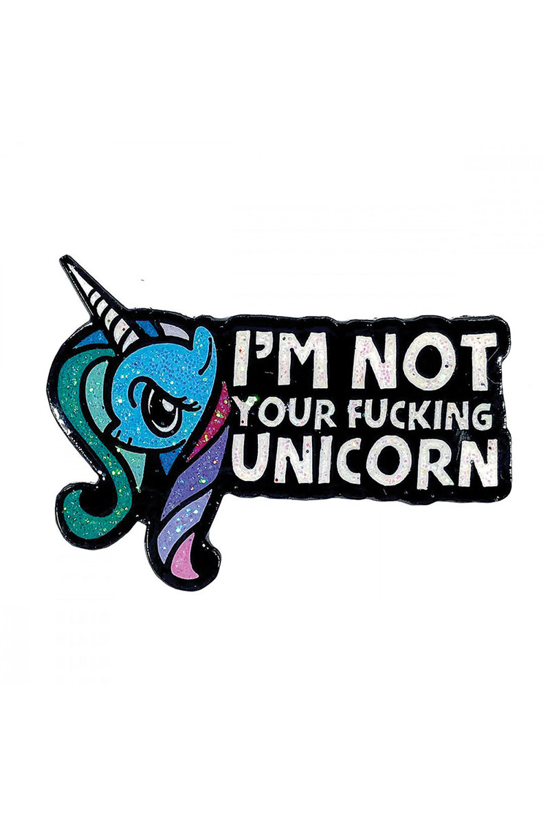 Glittery teal and purple side-profile unicorn enamel pin with a half-lidded annoyed expression next to a black banner reading I'M NOT YOUR FUCKING UNICORN.