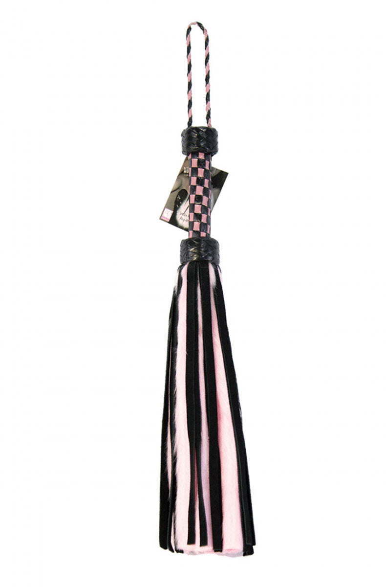 Detail view of the braided black knot joining pink faux-fur and black suede tails to the pink and black checkered handle.
