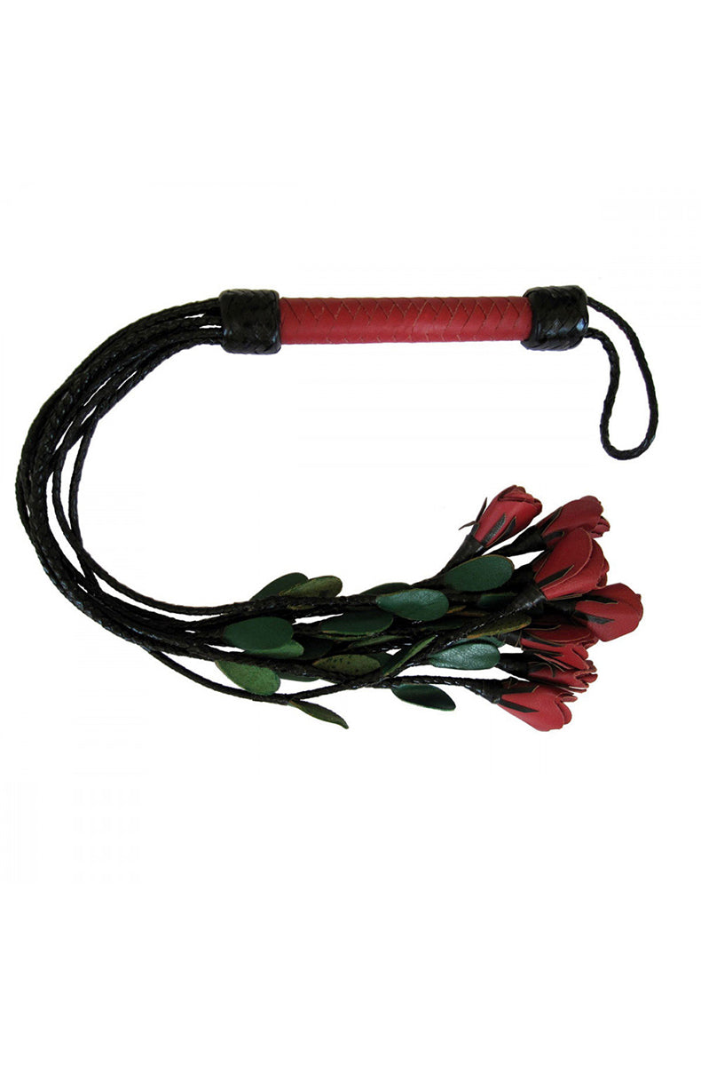 Real-leather flogger with braided black tails ending in red leather rose tips and green leather leaves on a woven red handle.
