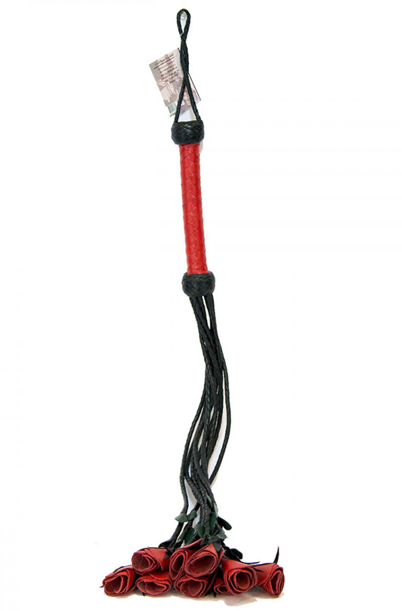 Full view of the red roses flogger hanging with red woven handle up and red rose tips resting at the bottom.
