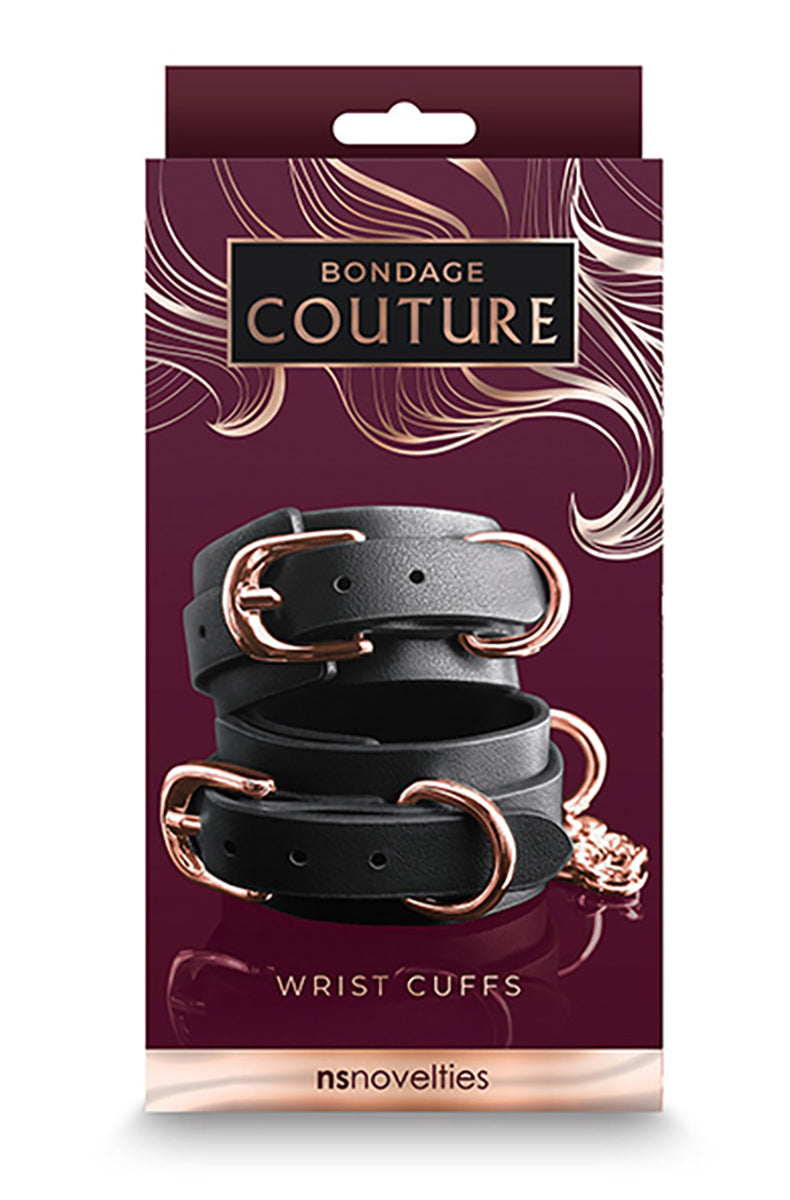 Bondage Couture Wrist Cuffs retail box in burgundy with rose-gold accents, showing the black cuffs with rose-gold hardware.