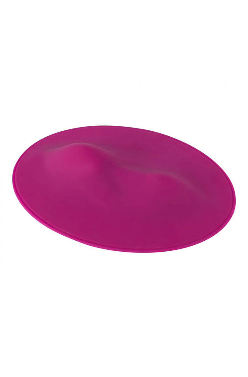 Flat lay of pink Vibepad showing oval shape and subtle ridge along center surface