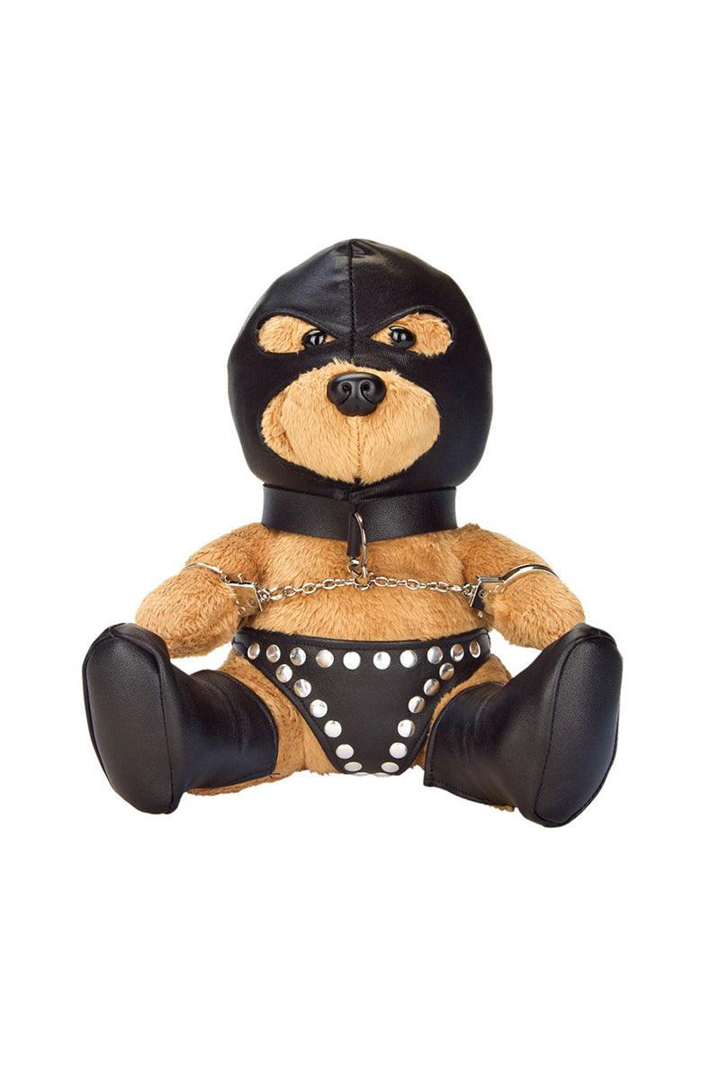 Tan plush teddy bear in black faux leather hood with eye holes, collar and chain, silver-studded panties, and black boots.