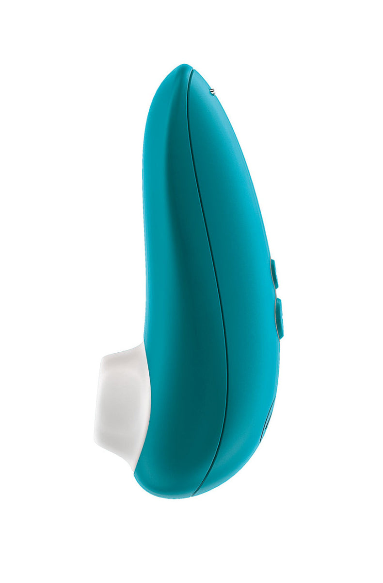 Side view of turquoise teal Womanizer Starlet 3 air-pulse clitoral toy with white silicone tip and two small side buttons.