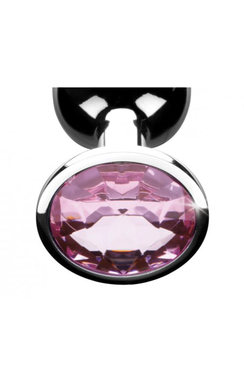 Booty Sparks medium pink-gem anal plug on a flat surface with retail packaging.