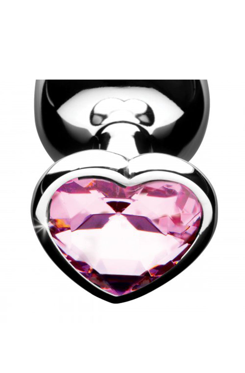 Pink heart gem anal plug set with all three sizes on a flat surface.
