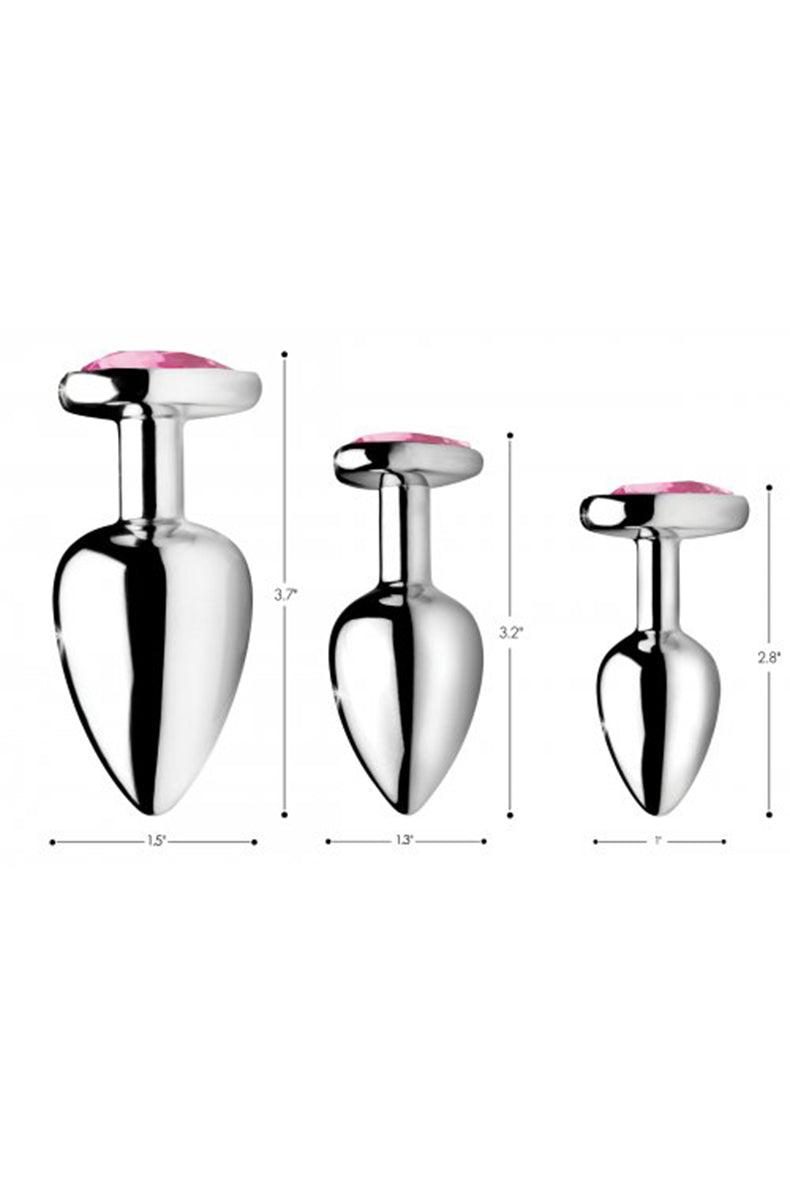 Single medium aluminum anal plug with pink heart flared base close-up.